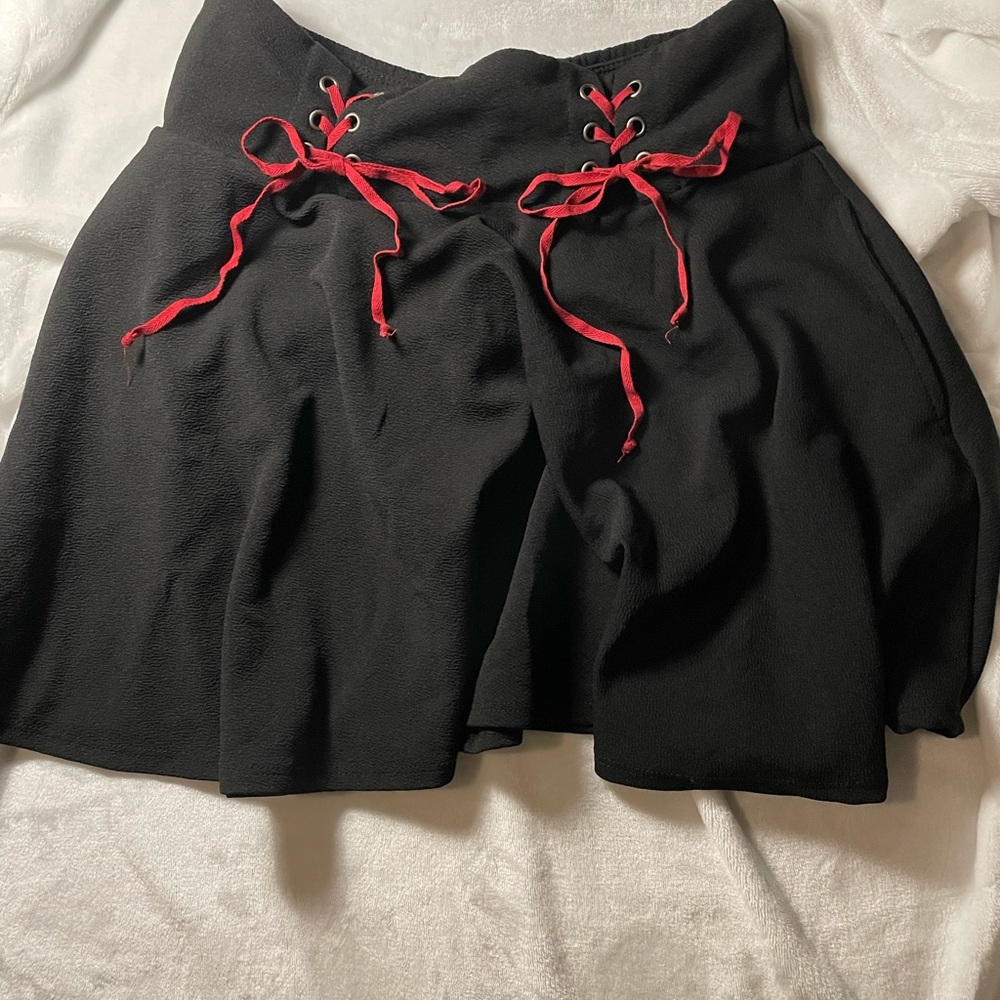 Black stretchy pleated skirt, size large, red ties